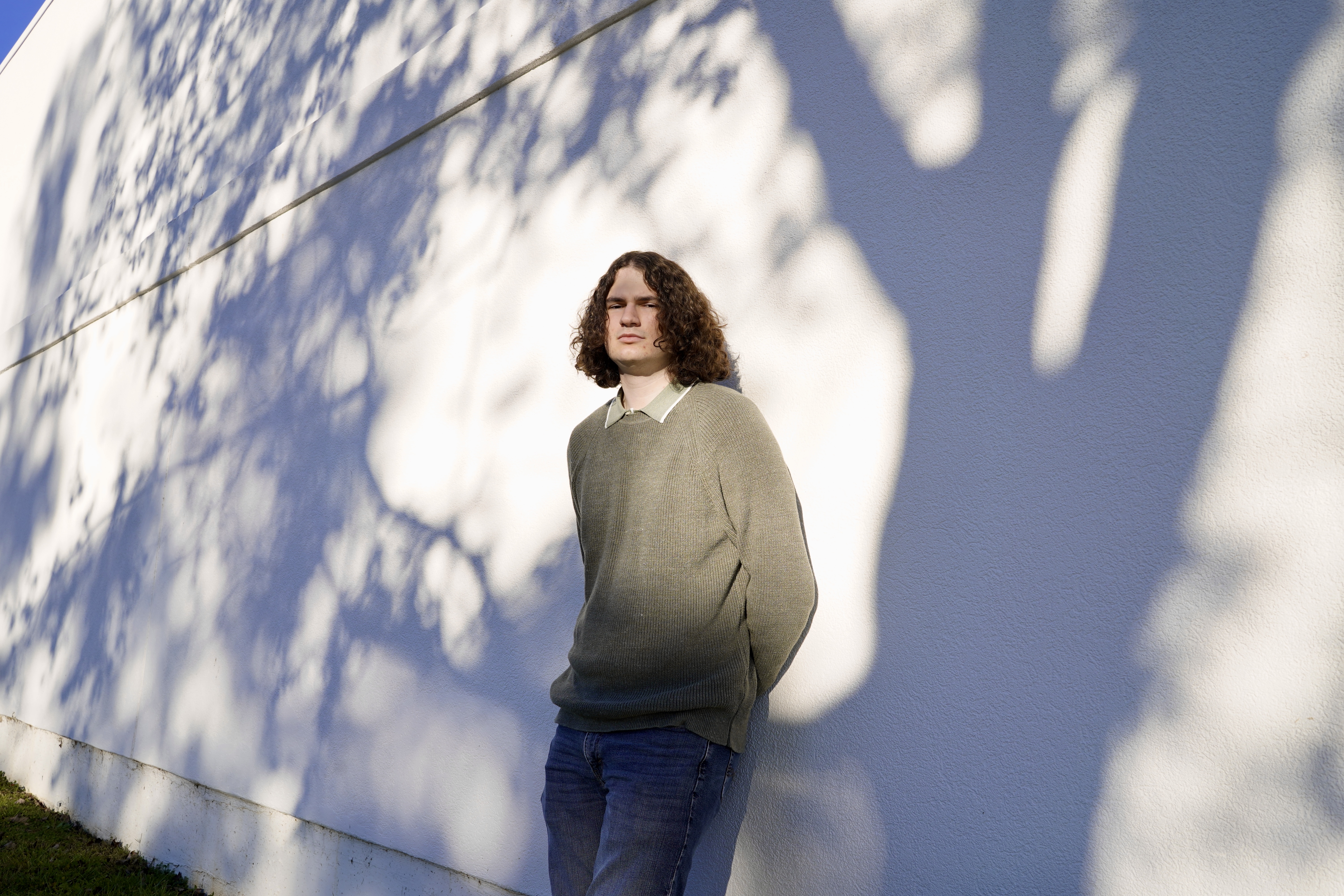 Taylor Sharp standing against a wall